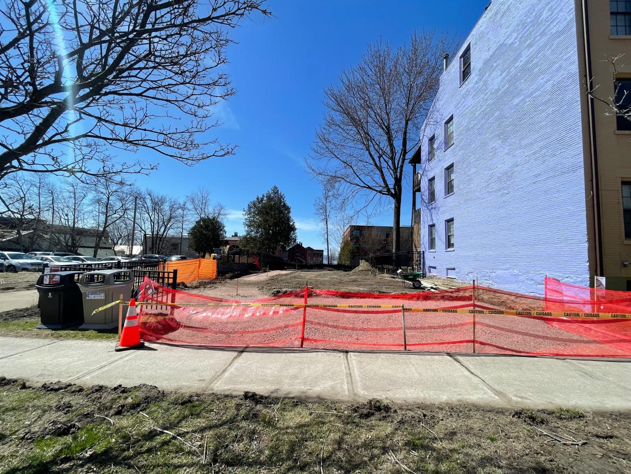 An orange construction fence blocks off Champlain Street Park, currently closed to the public while construction is underway. The project is estimated to run from April to June 2024 and will feature a new playground, seating, sidewalks and plants.