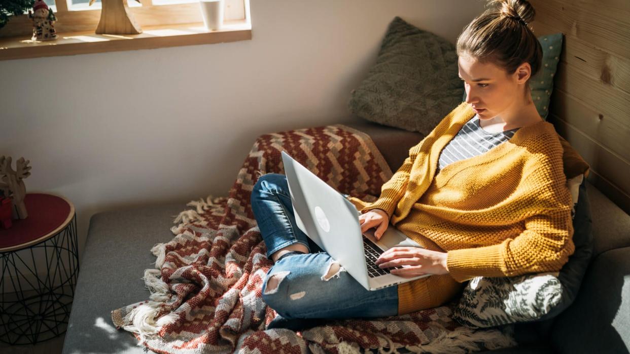 Young Pretty Woman at Home, Using Laptop, Sufring the Internet, Online Shopping.