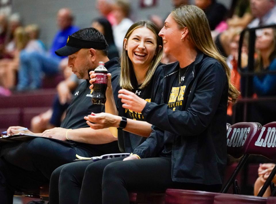 Bishop Verot assistants Mindie Mabry (left) and Chelsey Lockey (right) cheer for their team on Thursday, Oct. 5, 2023 against First Baptist Academy. Mabry and Lockey have helped Verot to a potential 20-win season for the first time since 2017.