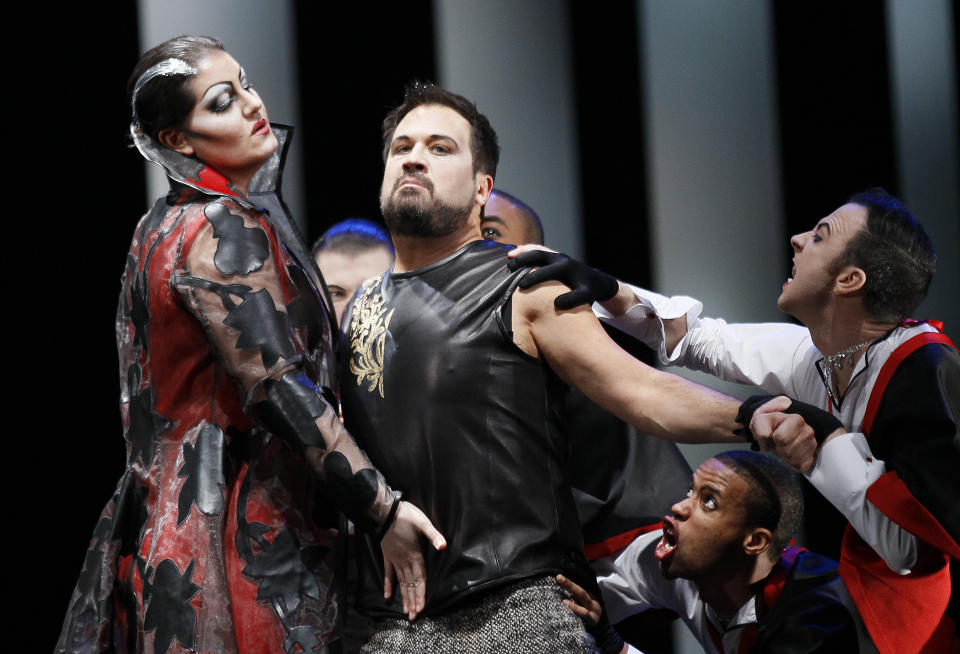 **HOLD FOR STORY ** FILE - In this Feb. 24, 2012 file photo, David Daniels, second from left, performs as Rinaldo, during the final dress rehearsal at the Lyric Opera of Chicago's production of Rinaldo. Daniels and his husband were arrested in 2019 and accepted a deal to plead guilty to sexual assault of an adult, a second-degree felony. Both were sentenced to eight years' probation and required to register as sex offenders. (AP Photo/Charles Rex Arbogast, File)