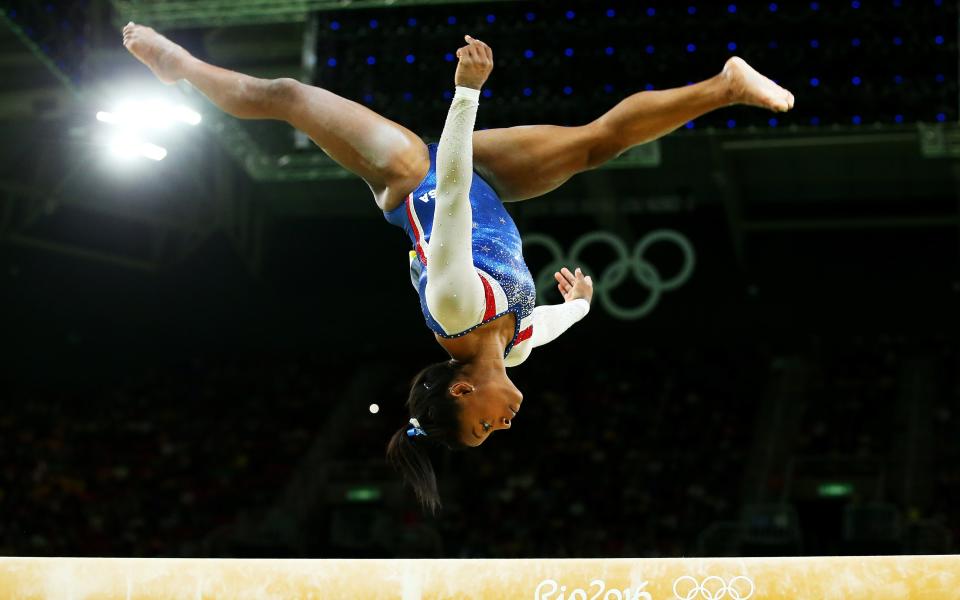 Simone Biles of the United States competes on the balance beam - Credit: Getty