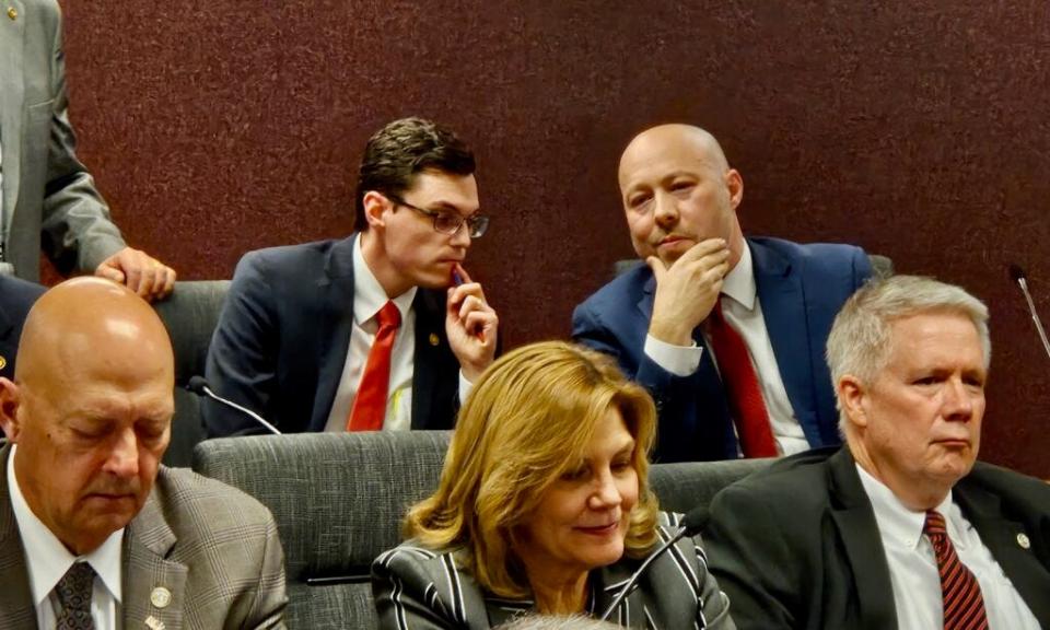 House Budget Committee Chairman Cody Smith, back right, confers with Vice Chairman Dirk Deaton during discussion of whether to suspend rules being used by Democrats to stretch out debate.