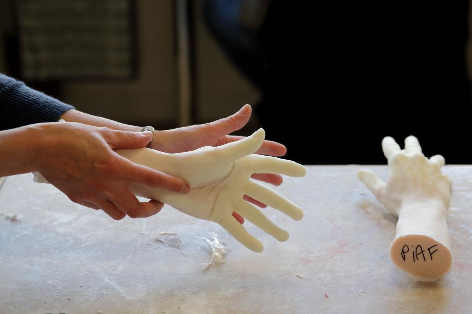 Wax hands for the statue of late French singer Edith Piaf are checked in the museum workshop in Paris