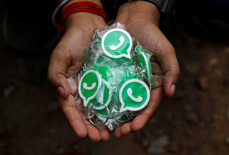 A WhatsApp-Reliance Jio representative displays key chains with the logo of WhatsApp for distribution during a drive by the two companies to educate users, on the outskirts of Kolkata, India, October 9, 2018. Picture taken October 9, 2018. REUTERS/Rupak De Chowdhuri