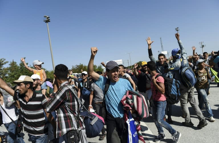 Syrian migrants and refugees chant as they march along the highway towards the Turkish-Greek border at Edirne on September 18, 2015