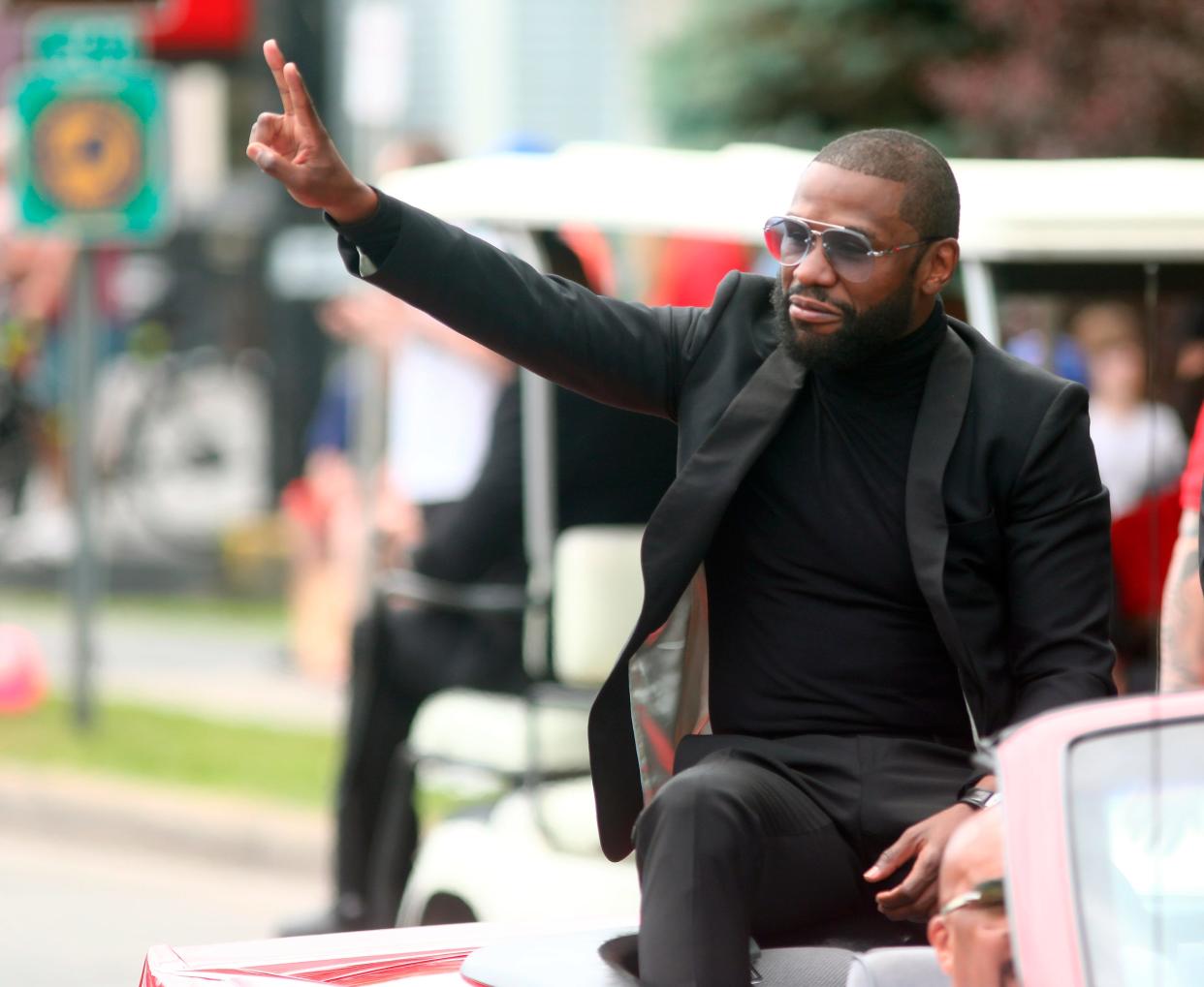 International Boxing Hall of Fame inductee Floyd Mayweather acknowledges paradegoers during the annual Parade of Champions on Sunday.