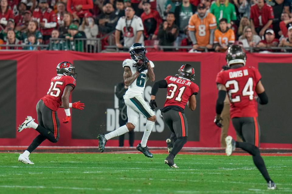 Philadelphia Eagles wide receiver DeVonta Smith (6) makes a catch in front of Tampa Bay safety Antoine Winfield Jr. (31), cornerback Jamel Dean (35) and cornerback Carlton Davis III (24) during an NFL wild-card playoff game, Monday, Jan. 15, 2024, in Tampa, Fla.