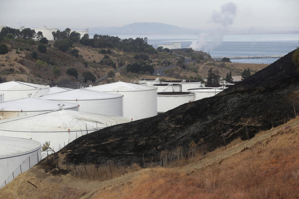A burned hillside is shown from a Tuesday fire at NuStar Energy fuel storage facility in Crockett, Calif., Wednesday, Oct. 16, 2019. Officials were trying to determine Wednesday if a 4.5 magnitude earthquake triggered an explosion at the fuel storage facility in the San Francisco Bay Area that started a fire and trapped thousands in their homes for hours because of potentially unhealthy air. (AP Photo/Jeff Chiu)