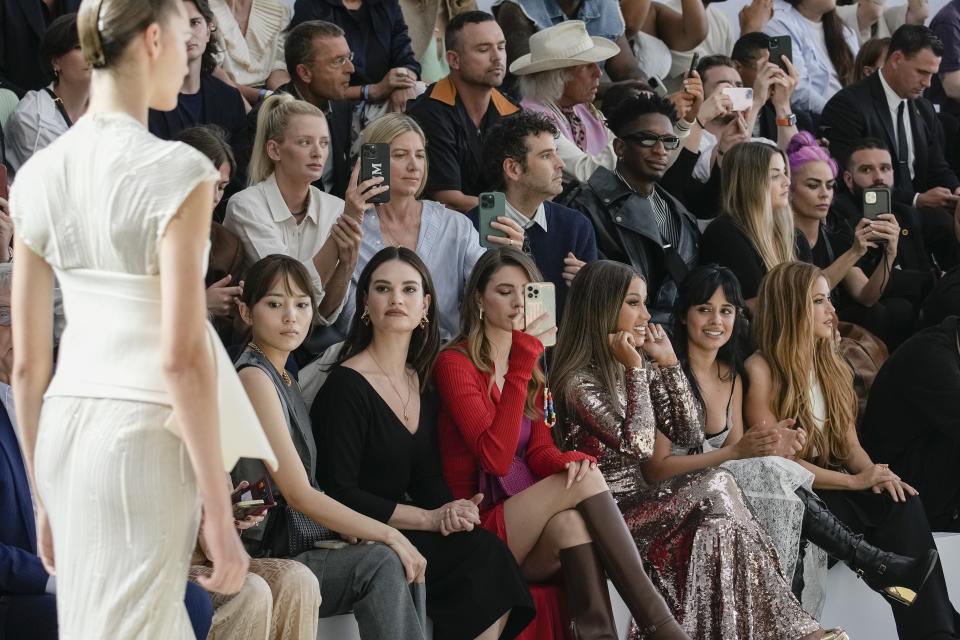 Shakira, from bottom right, Camila Cabello, Cardi B and Lily James, fifth from right, attend the Fendi Haute Couture Fall/winter 2023-2024 fashion collection presented in Paris, Thursday, July 6, 2023. (AP Photo/Christophe Ena)