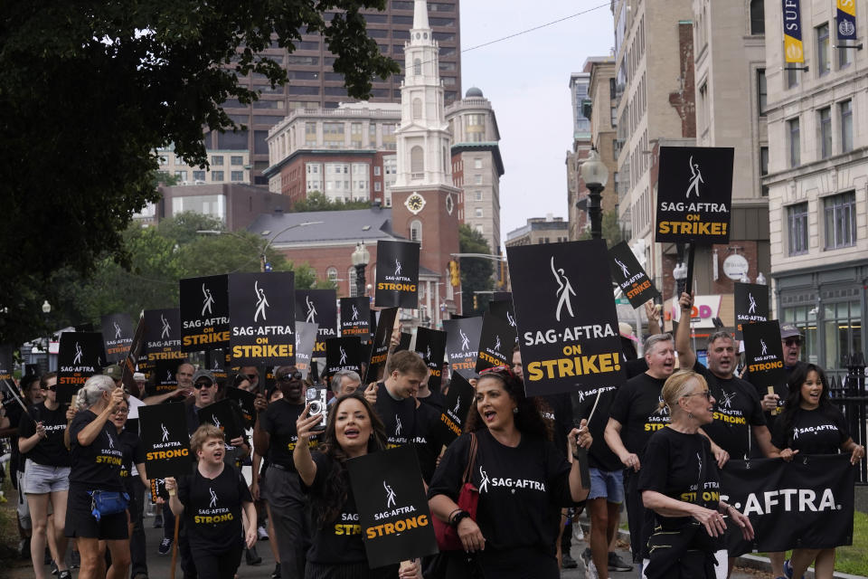 Striking film and television actors and supporters display signs and chant slogans while marching, Wednesday, July 19, 2023, in Boston. (AP Photo/Steven Senne)