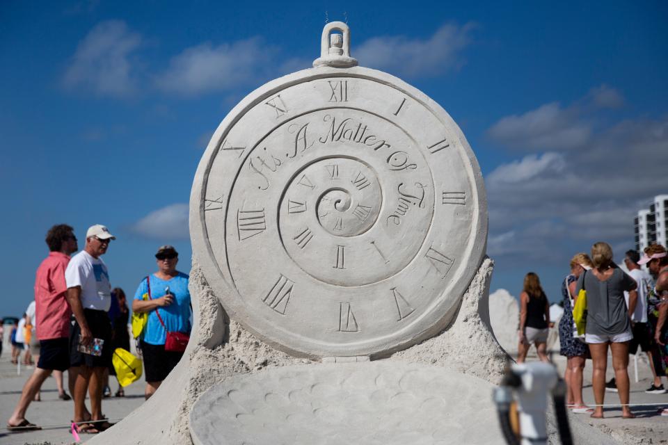 Attendees look at John Gowdy's sand sculpture titled "Soul Reunion" during the 33rd annual American Sand Sculpting Championship at Wyndham Garden Hotel in Fort Myers Beach on Sunday, November 24, 2019. 