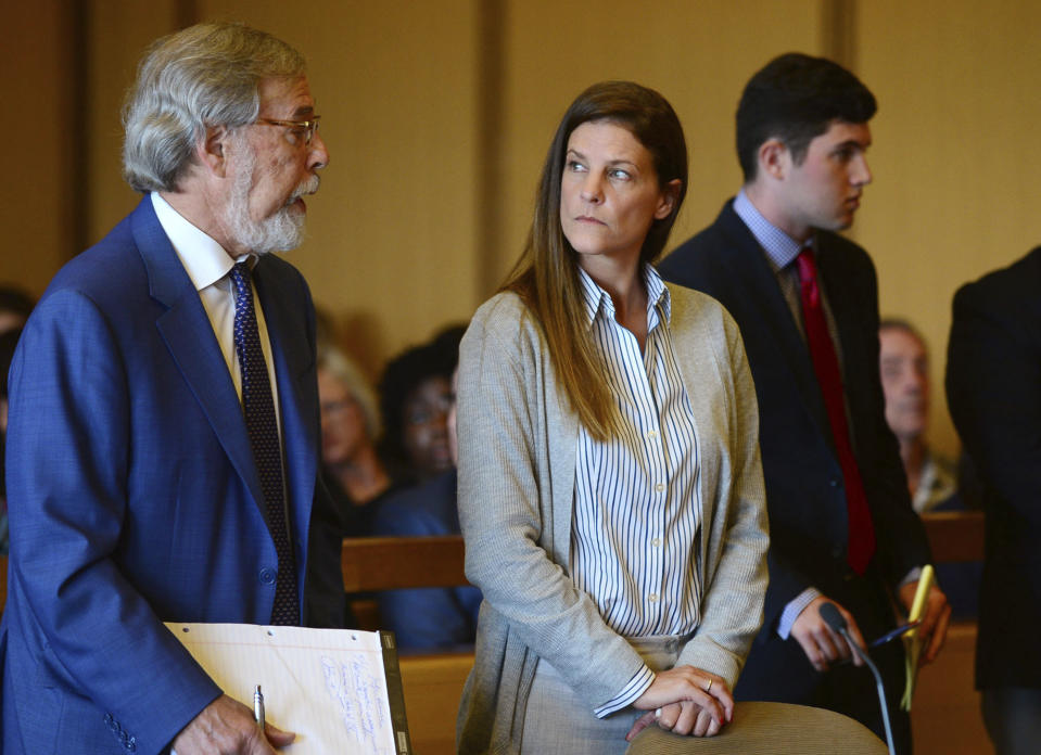 Michelle Troconis, center, listens as a member of her legal team Andrew Bowman, left, addresses the court during a hearing at Stamford Superior Court, Tuesday, June 11, 2019 in Stamford, Conn. Fotis Dulos, and his girlfriend, Michelle Troconis, have been charged with evidence tampering and hindering prosecution in the disappearance of his wife Jennifer Dulos. The mother of five has has been missing since May 24. (Erik Trautmann/Hearst Connecticut Media via AP, Pool)