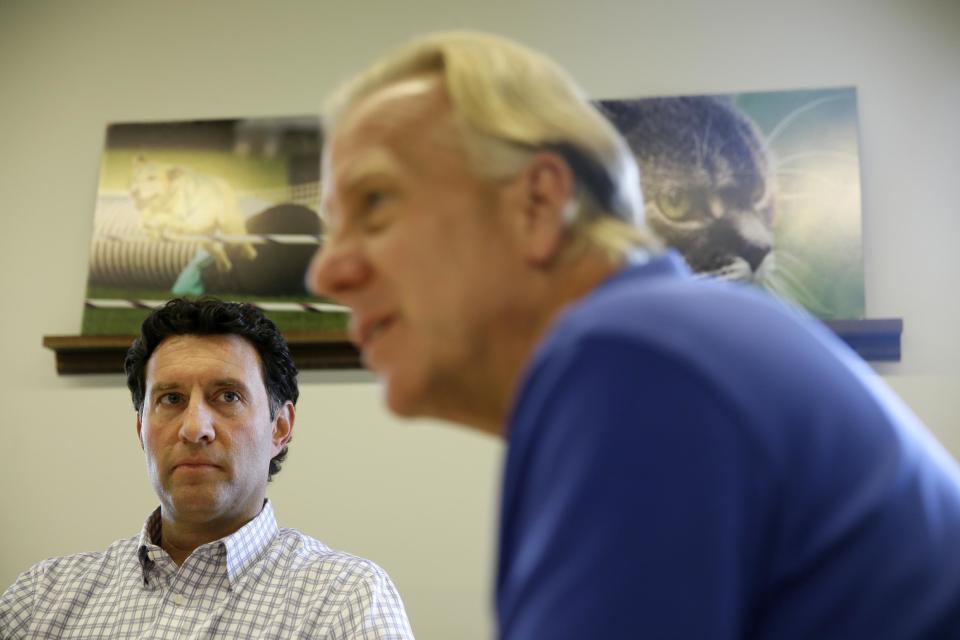 In this Tuesday, Oct. 1, 2013, photo, Freshpet co-founder and president Scott Morris, left, watches as CEO Richard Thompson talks with an Associated Press reporter during an interview at the pet food company's kitchen in Bethlehem, Pa. Freshpet uses fresh meat, poultry and vegetables in a pricey, preservative-free product that requires refrigeration. Sales exceed $100 million. (AP Photo/Matt Slocum)