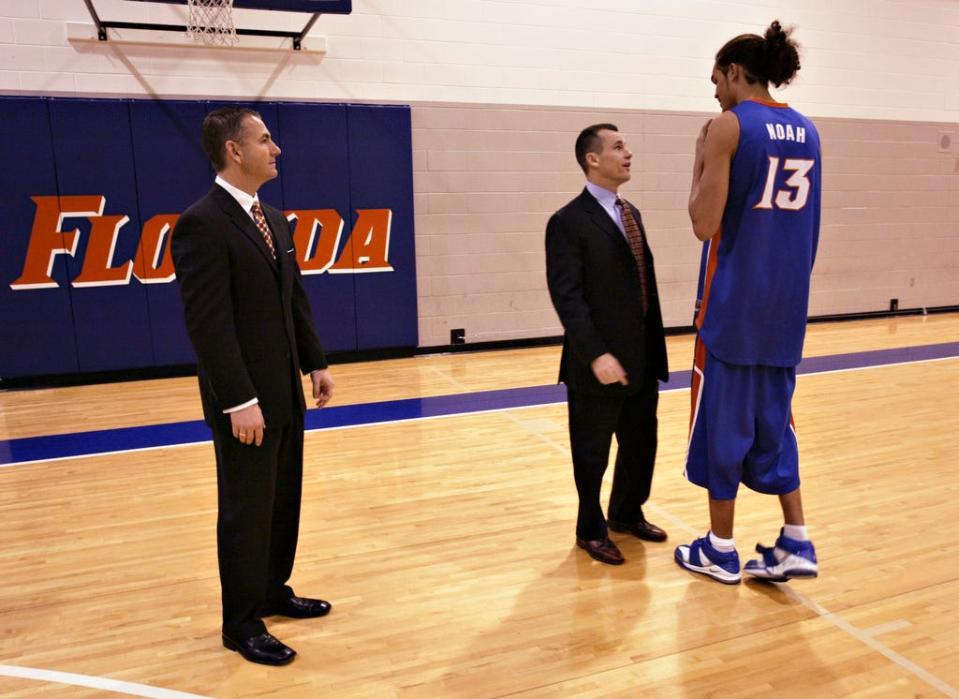 Billy Donovan jokes with sophomore Joakim Noah while assistant coach Donnie Jones looks on after the team picture was taken at the basketball practice facility on January 16, 2006.