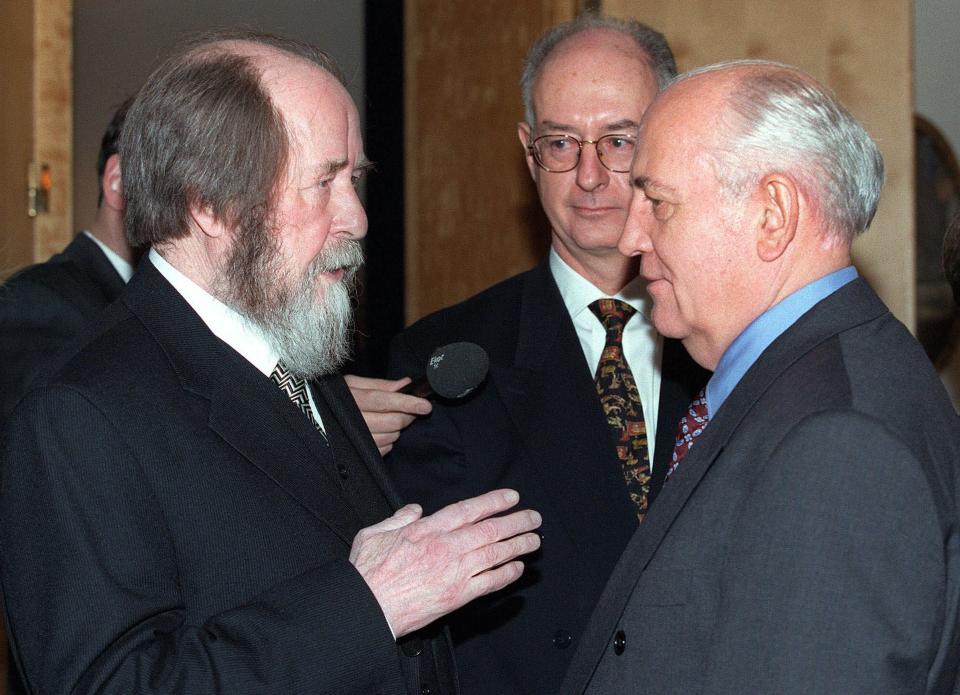 FILE - Writer Alexander Solzhenitsyn, left, speaks with former Soviet leader Mikhail Gorbachev as Swedish Ambassador Sven Hirdman, center, looks on at the Swedish Embassy where Solzhenitsyn and other Nobel laureates are feted in Moscow, Thursday, December 10, 1998. Gorbachev loosened up on the dreaded police state, which sowed fear through society, freed political prisoners such as Alexander Solzhenitsyn and Andrei Sakharov, and ended the Communist Party's monopoly on political power. Freer foreign travel, emigration and religious observance were also part of the mix. (AP Photo/Alexander Zemlianichenko, File)