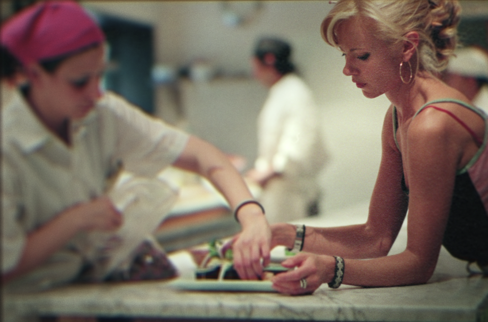 sarma and a chef plating food in the kitchen