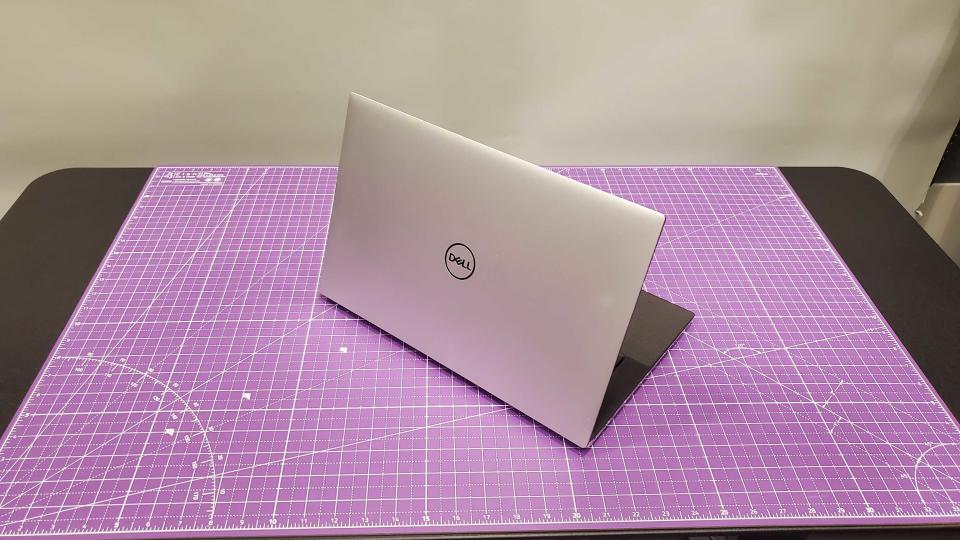 silver laptop sitting on purple desk