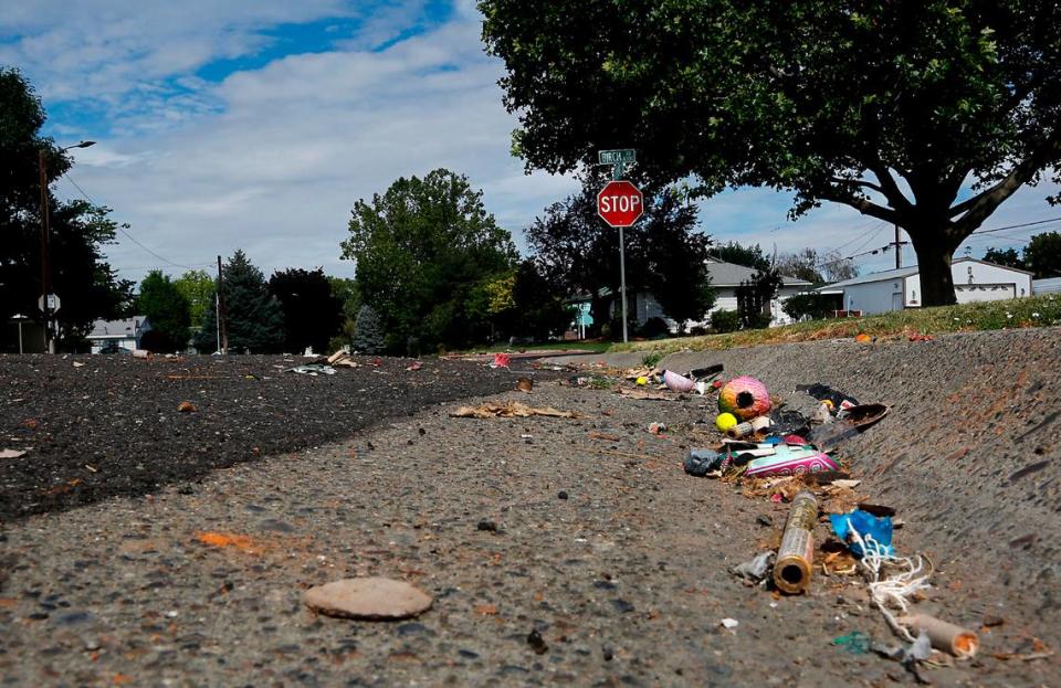 Debris from spent fireworks litters the gutter and roadway on Sacramento Boulevard near the intersection with Birch Avenue Tuesday morning in Richland.