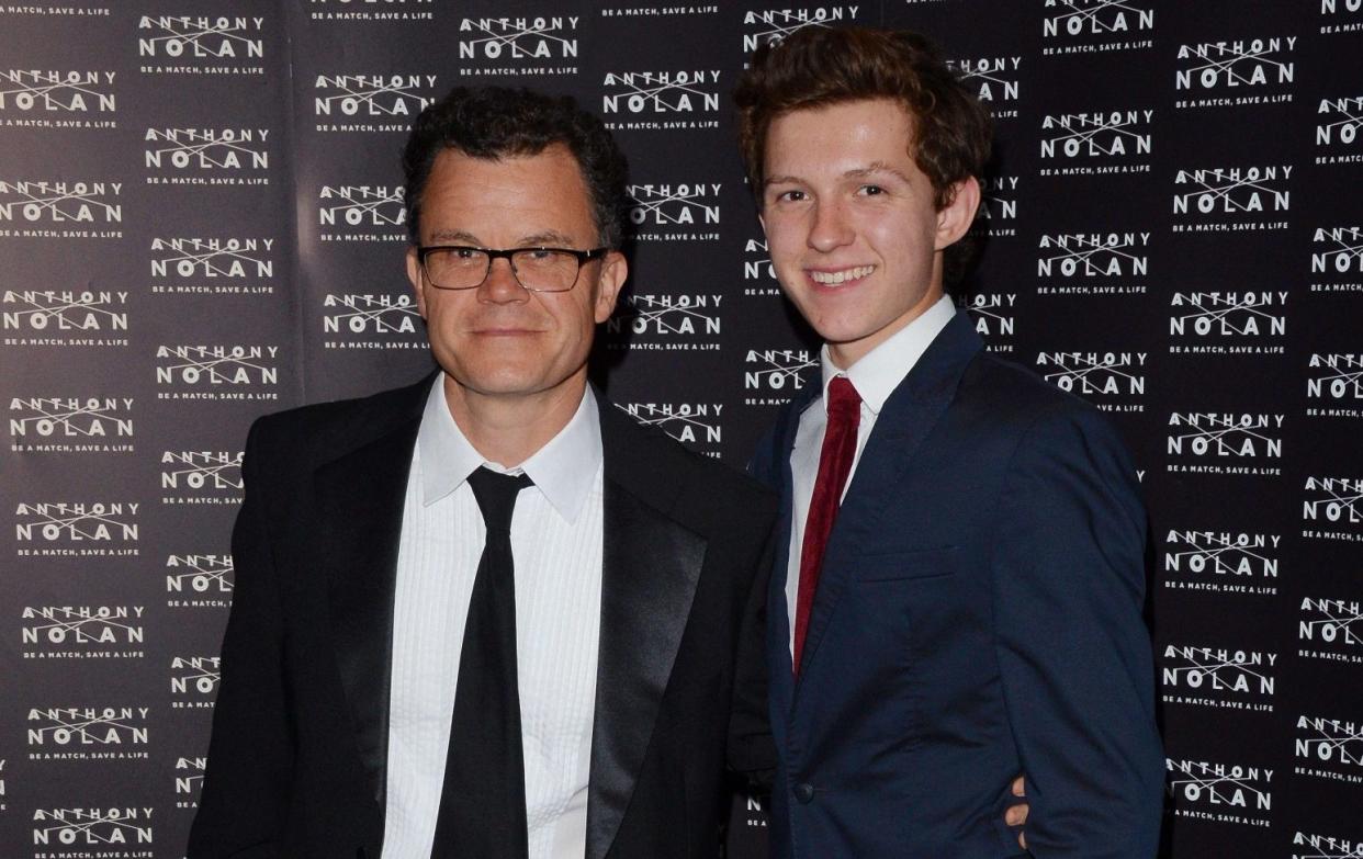 Dominic Holland with his son, Tom, at the Grosvenor House Hotel in 2014 - Alamy