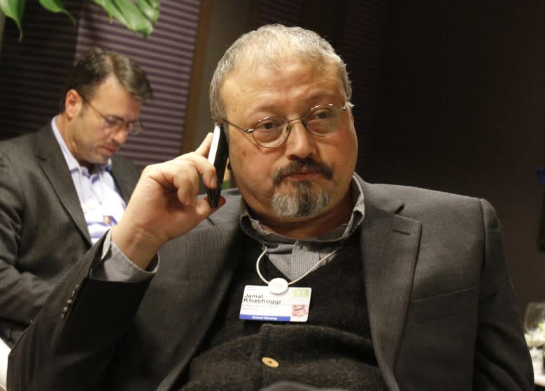 FILE - In this Jan. 29, 2011, file photo, Saudi Arabian journalist Jamal Khashoggi speaks on his cellphone at the World Economic Forum in Davos, Switzerland. Saudi Arabia issued an unusually strong rebuke of the U.S. Senate on Monday Dec. 17, 2018, rejecting a bipartisan resolution that put the blame for the killing of Saudi journalist Jamal Khashoggi squarely on the Saudi crown prince and describing it as interference in the kingdom's affairs. (AP Photo/Virginia Mayo, File)