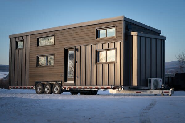 Quebec-based Minimaliste fabricates ten mobile tiny home models available across North America, as well as five types of ADUs for sale in Canada. Their most spacious offering the standard line, the 400-square-foot Charme model pictured houses one enclosed bedroom and two lofted sleeping areas.