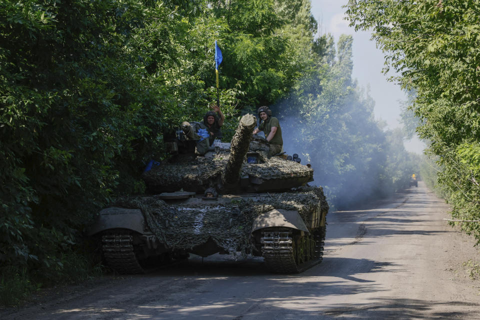 FILE - Ukrainian servicemen ride atop on a tank T-64 at the front line near Bakhmut, Donetsk region, Ukraine, Monday, July 3, 2023. Ukrainian forces are making steady progress along the northern and southern flanks of Bakhmut, in a semi-encirclement of the wrecked city that Russian forces have been occupying since May. (AP Photo/Alex Babenko, File)