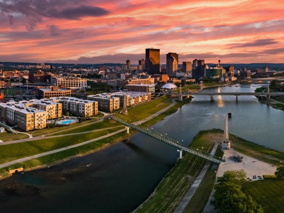 A panoramic aerial drone view over the confluence of the Great Miami and Mad Rivers looking toward downtown Dayton, Ohio.