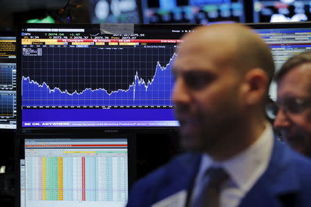 A trader works on the floor of the New York Stock Exchange (NYSE) shortly after the opening bell in New York December 17, 2015. REUTERS/Lucas Jackson