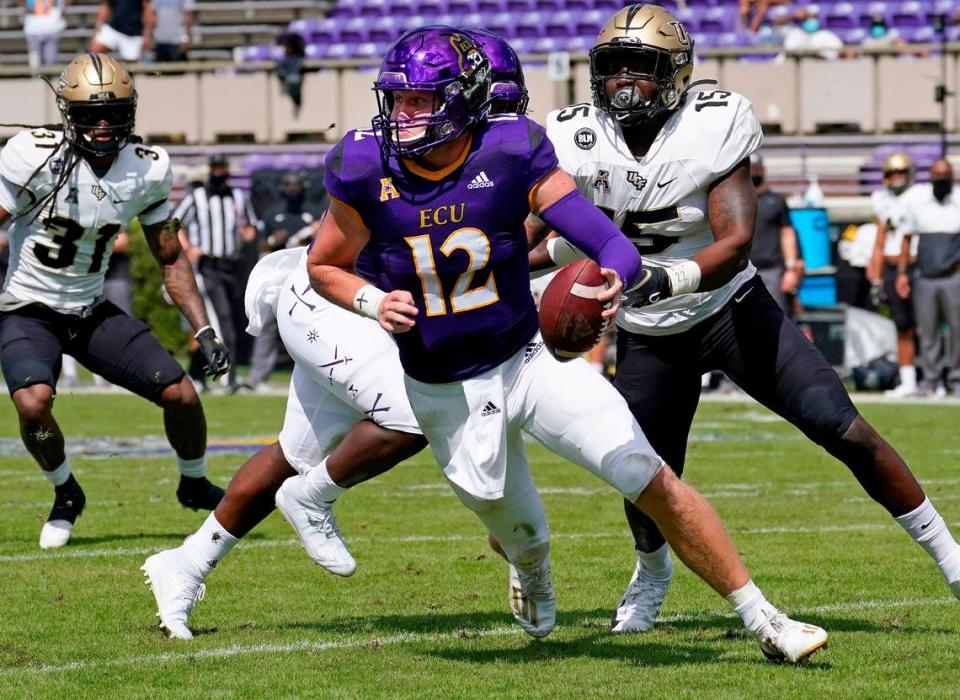 East Carolina quarterback Holton Ahlers (12) scrambles as Central Florida linebacker Tatum Bethune (15) chases during their game in Greenville, N.C., Saturday, Sept. 26, 2020. In eight appearances last season, Ahlers threw 18 touchdowns to nine interceptions and 1921 yards with a 61% completion percentage. Gerry Broome/AP