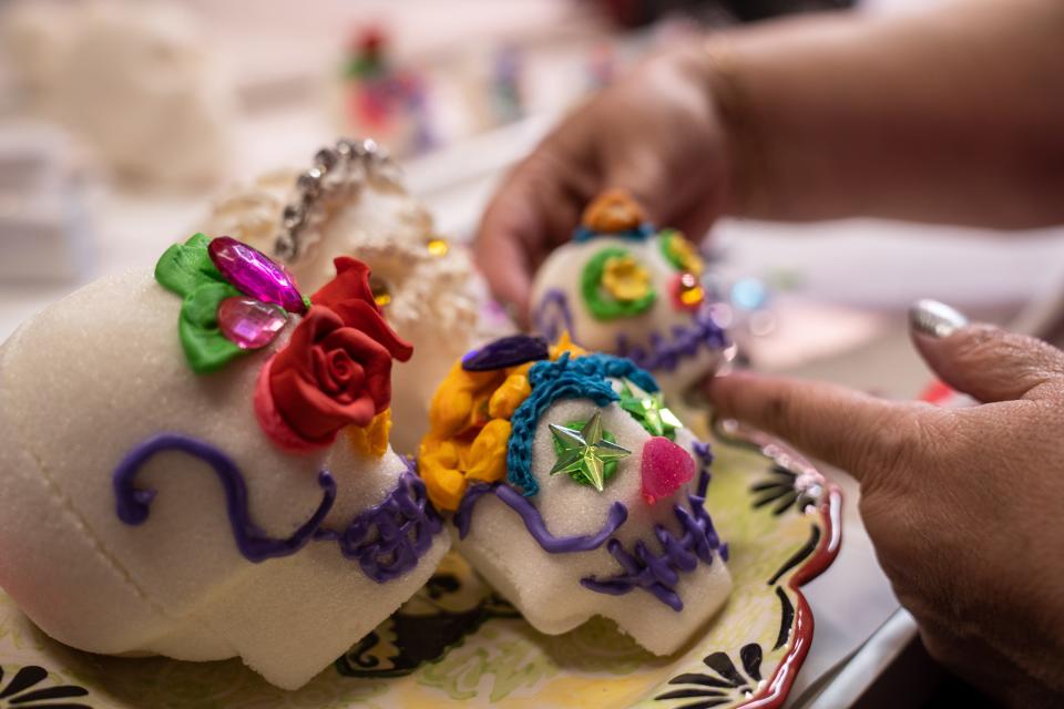 Kathy Cano-Murillo of Crafty Chica decorates Dia De Los Muertos sugar skulls at her home in Phoenix on Oct. 25, 2023.