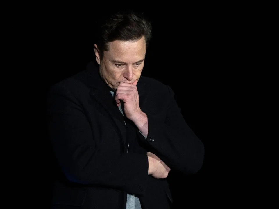 Elon Musk looks down during a 2022 SpaceX speech