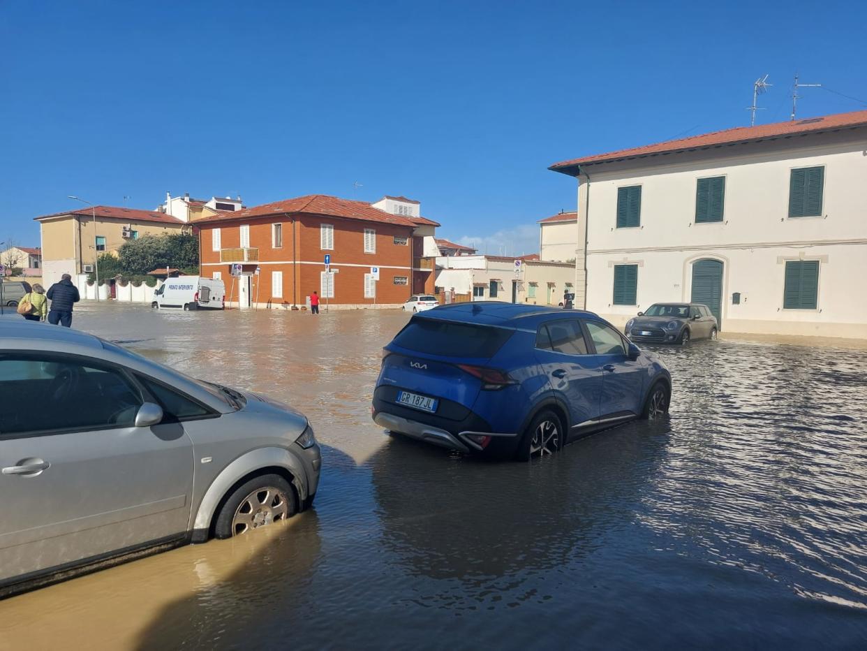 Cars in the town partly submerged following heavy flooding 