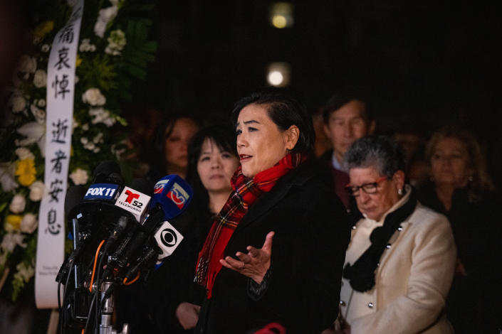 Rep. Judy Chu speaks into a microphone with a group of people behind her.