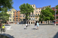 People walk in the Campo del Ghetto Nuovo (New Ghetto Grounds) in Venice, northern Italy, Wednesday, June 1, 2022. Venice’s Jewish ghetto is considered the first in Europe and one of the first in the world, and a new effort is underway to preserve its 16th century synagogues for the Jews who have remained and tourists who pass through. (AP Photo/Chris Warde-Jones)