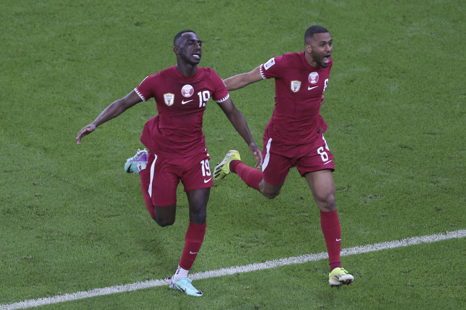 Qatar's Almoez Ali, left, celebrates with teammates after scoring goal during the Asian Cup semifinal soccer match between Qatar and Iran at Al Thumama Stadium in Doha, Qatar, Wednesday, Feb. 7, 2024. (AP Photo/Hussein Sayed)