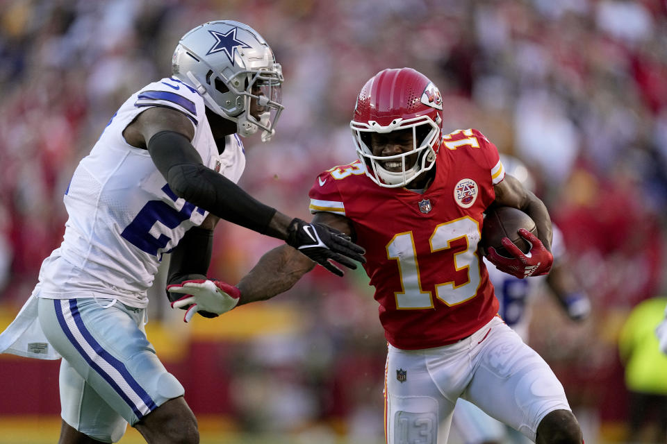 Kansas City Chiefs wide receiver Byron Pringle (13) gains a first down past Dallas Cowboys safety Jayron Kearse (27) during the first half of an NFL football game Sunday, Nov. 21, 2021, in Kansas City, Mo. (AP Photo/Charlie Riedel)