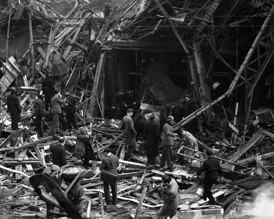 FILE - In this March 8, 1945 file photo rescue workers search for victims after one of the worst of the Nazi V-bomb attacks on London during World War II. The United Kingdom has suffered its worst civilian loss of life since World War II by a significant number. Some 70,000 non-combatants perished in the 1940s. 75 years later, it's 100,000 taken by the coronavirus pandemic, an enemy no less relentless and fearsome and one whose defeat is still some time away. (AP Photo, File)