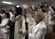 <p>A woman wears a crown and holds an unloaded weapon during services at the World Peace and Unification Sanctuary, Wednesday Feb. 28, 2018 in Newfoundland, Pa. (Photo: Jacqueline Larma/AP) </p>