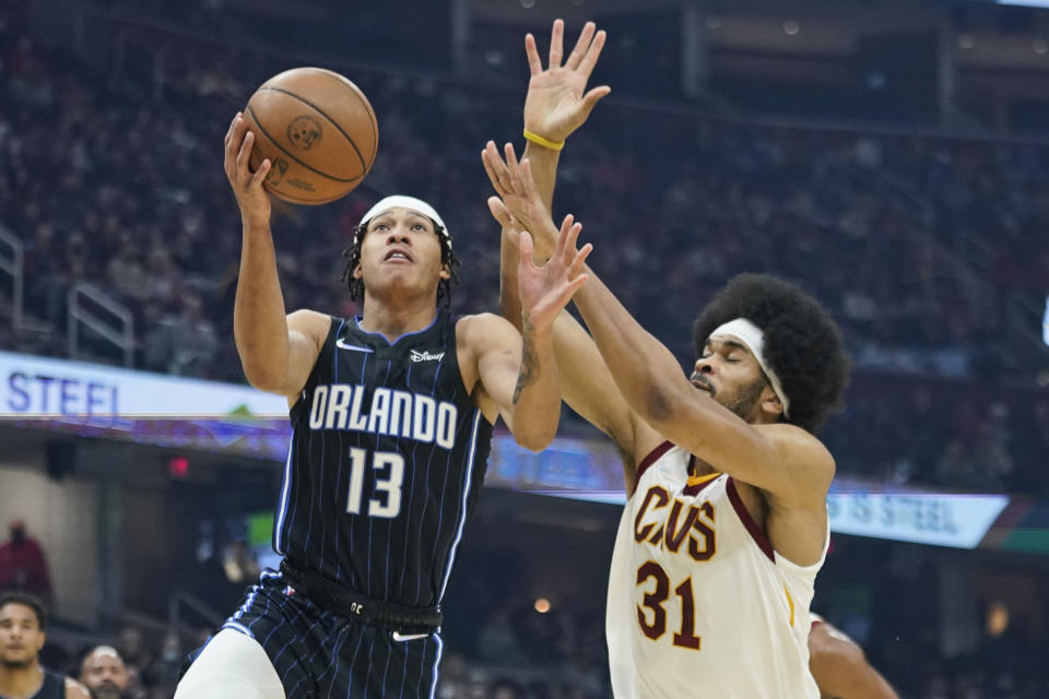 Orlando Magic's R.J. Hampton (13) drives to the basket against Cleveland Cavaliers' Jarrett Allen (31) in the first half of an NBA basketball game, Saturday, Nov. 27, 2021, in Cleveland. (AP Photo/Tony Dejak)