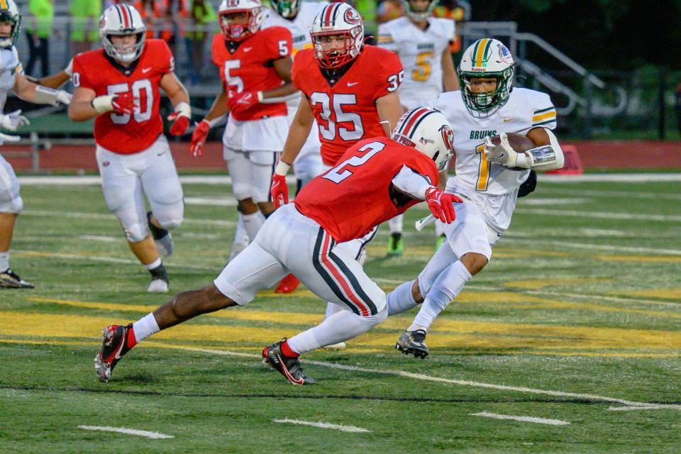 Rock Bridge's Drevyn Seamon (1) makes the cut before Jefferson City's Rodney Wilson (2) can get to him during the Bruins' 49-27 win on Sept. 9, 2022.