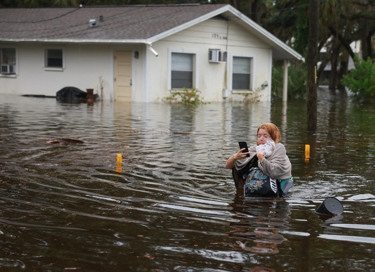 Makatla Ritchter wades through flood waters after having to evacuate her home when the flood waters from Hurricane Idalia inundated it on August 30, 2023 in Tarpon Springs, Florida.  (Joe Raedle/Getty Images)