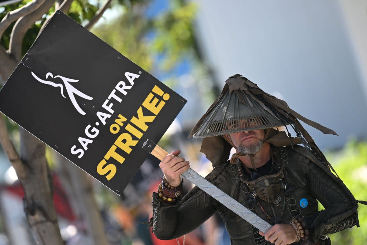 Standing ground: a Sag-Aftra picketer outside Netflix headquarters on 8 November (AFP via Getty Images)