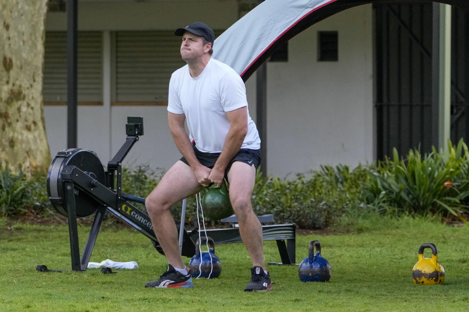 A man workout with gym equipment in a park in the eastern suburbs of Sydney Tuesday, Sept. 14, 2021. Personal trainers have turned a waterfront park at Sydney’s Rushcutters Bay into an outdoor gym to get around pandemic lockdown restrictions. (AP Photo/Mark Baker)