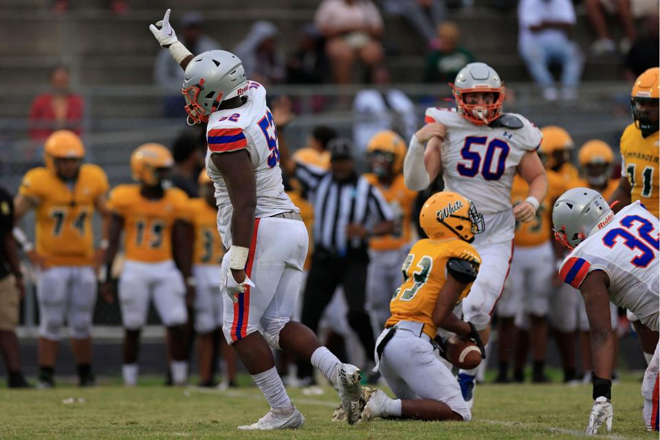 Bolles defensive lineman Garrison Butler (52) reacts to a tackle against Ed White in the spring game.