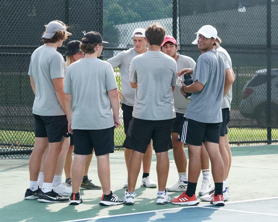 The Adrian College men's tennis team huddles up prior to a dual against Huntington.