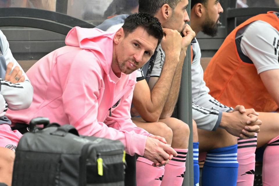 Inter Miami's Argentine forward Lionel Messi (L) sits on the bench during the friendly football match between Hong Kong XI and US Inter Miami CF in Hong Kong on February 4, 2024. Inter Miami were booed off the pitch after their injured superstar Lionel Messi failed to take the field in a pre-season friendly in Hong Kong.