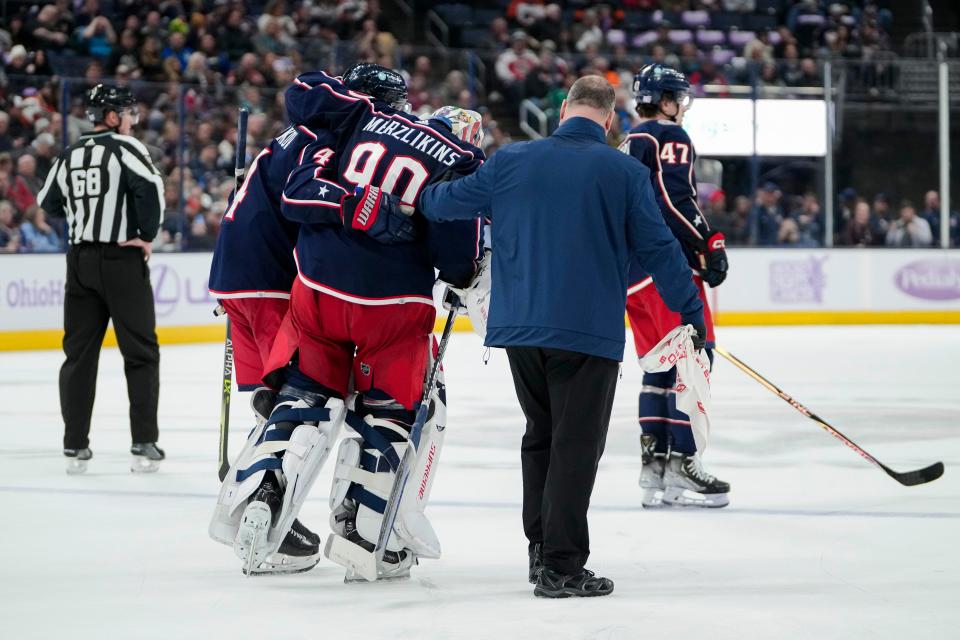 Nov 15, 2022; Columbus, Ohio, USA;  Columbus Blue Jackets goaltender Elvis Merzlikins (90) leaves the game with an apparent injury during the second period of the NHL hockey game against the Philadelphia Flyers at Nationwide Arena. Mandatory Credit: Adam Cairns-The Columbus Dispatch