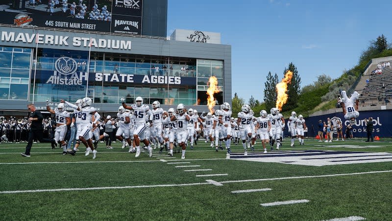 The Utah State Aggies take the field at Maverik Stadium.