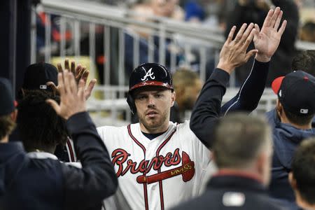 Apr 1, 2019; Atlanta, GA, USA; Atlanta Braves first baseman Freddie Freeman (5) reacts in the dugout with teammates after scoring a run against the Chicago Cubs during the sixth inning at SunTrust Park. Mandatory Credit: Dale Zanine-USA TODAY Sports