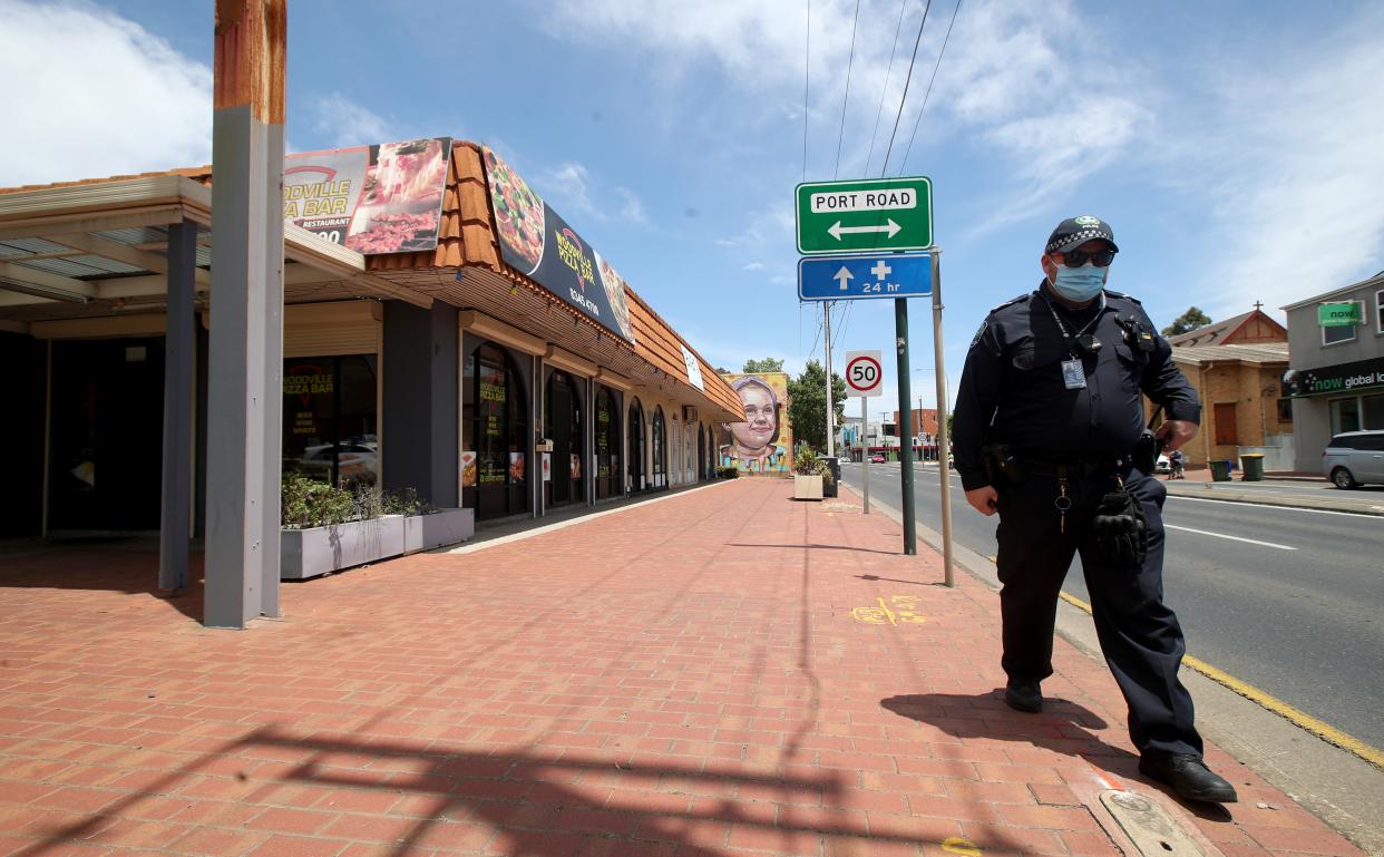 <p>Police outside the Woodville Pizza Bar after it was announced that a worker from the shop ‘lied’ to authorities during a Covid investigation</p> (Getty Images)